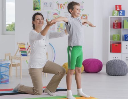 physiotherapist-exercising-with-a-school-boy-1536x1024