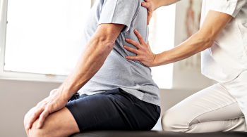 A Modern rehabilitation physiotherapy worker with senior client